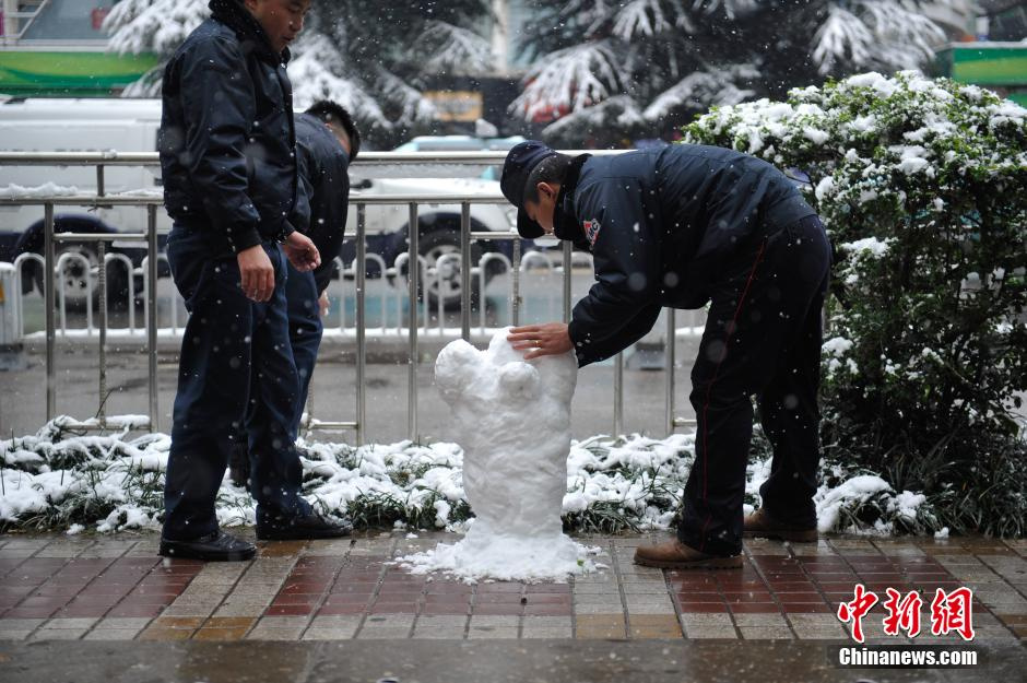 2013年12月16日，市民在街头打雪仗。受到强冷空气影响，昆明15日、16日连续降雪，城区一片银装素裹，分外美丽。