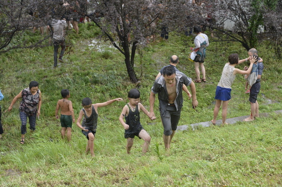 8月22日，在浙江海宁盐仓观潮点，护堤下的各种车辆被潮水冲倒。当日，受今年第十二号台风“潭美”的影响，今天海宁的潮水比以往高出了很多，在浙江海宁盐仓观潮点，不少观潮群众被大潮汛冲下护堤，淋湿衣物。