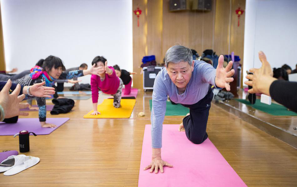 2017年3月15日，浙江省杭州市，乐老师在给学员们上瑜伽课。73岁的“瑜伽爷爷”乐明潮在杭州几个社区里免费开班教瑜伽已经有两年时间了，人气越来越旺。图为老爷爷上课摄影图。